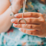 Sterling silver half moon necklace being held - womens jewellery by Australian jewellery brand indie and Harper 