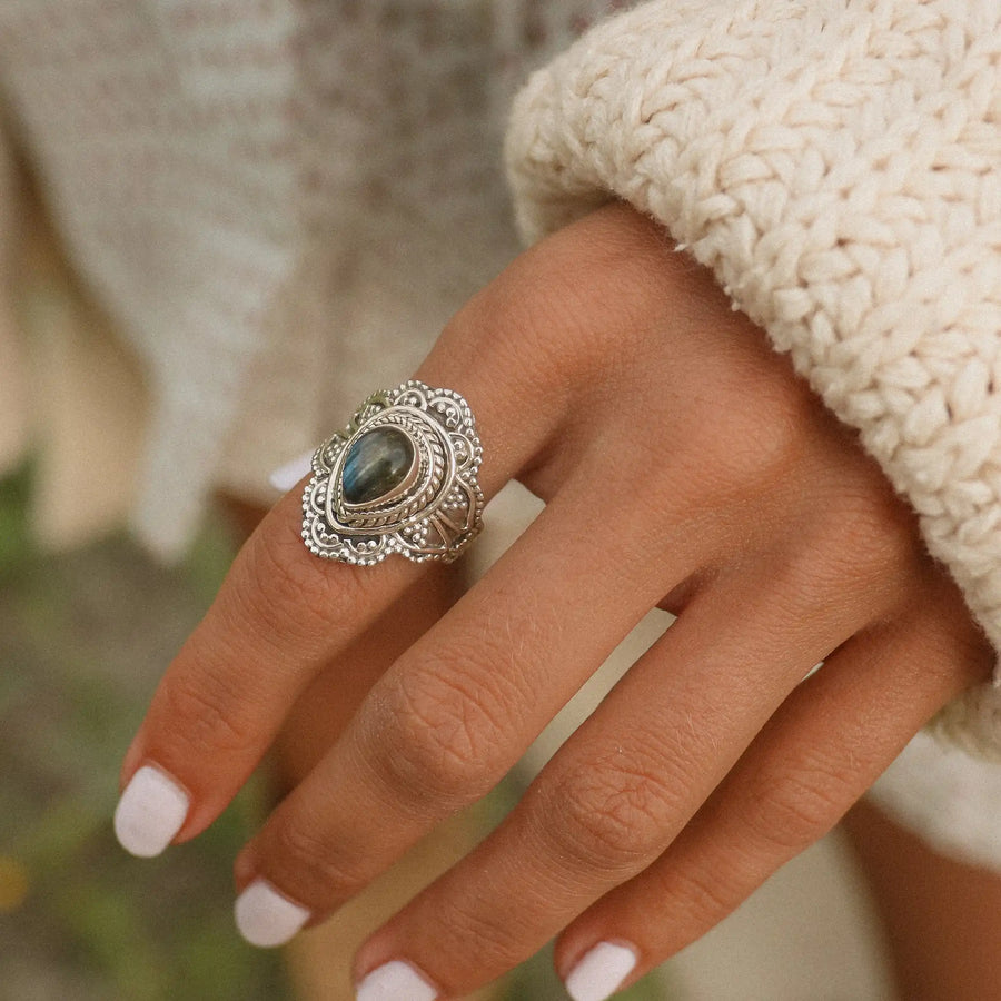 woman wearing a white sweater and a sterling silver labradorite ring - boho jewelry by womens jewellery brand indie and Harper 