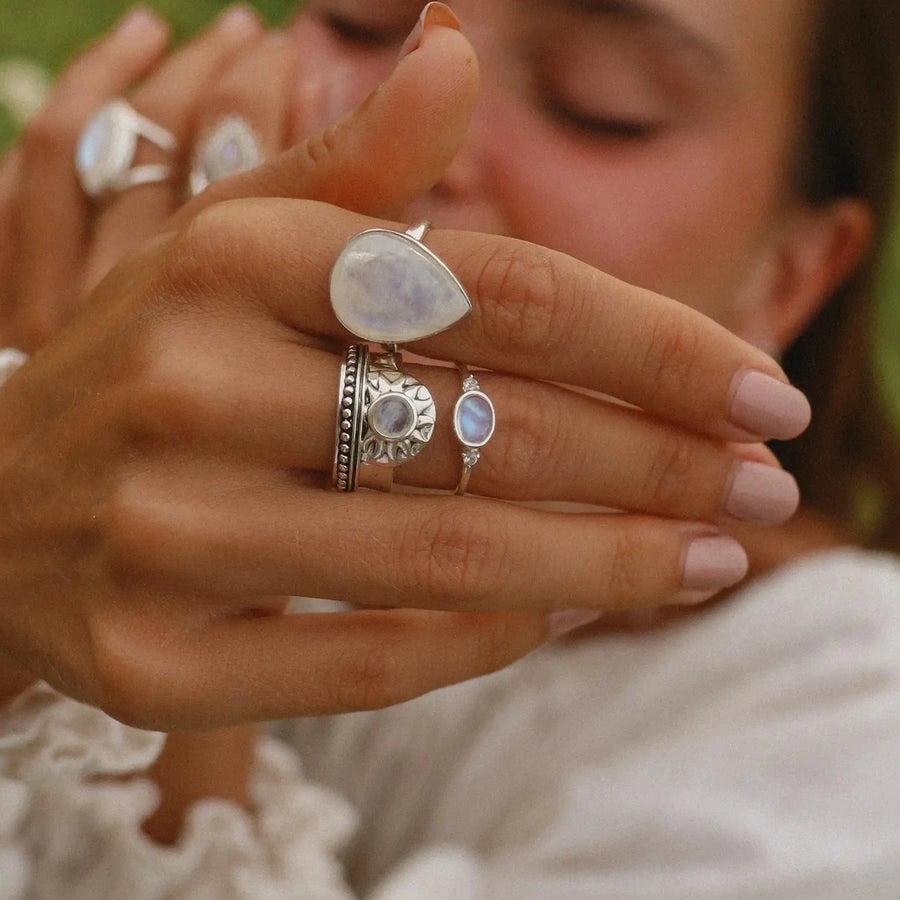 Woman showing her hand wearing three moonstone rings - moonstone jewellery by australian online jewellery brand indie and harper