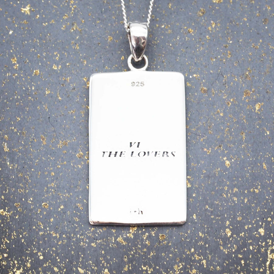 the lovers tarot card necklace with english translation on the back of the pendant by online jewellery brand indie and harper