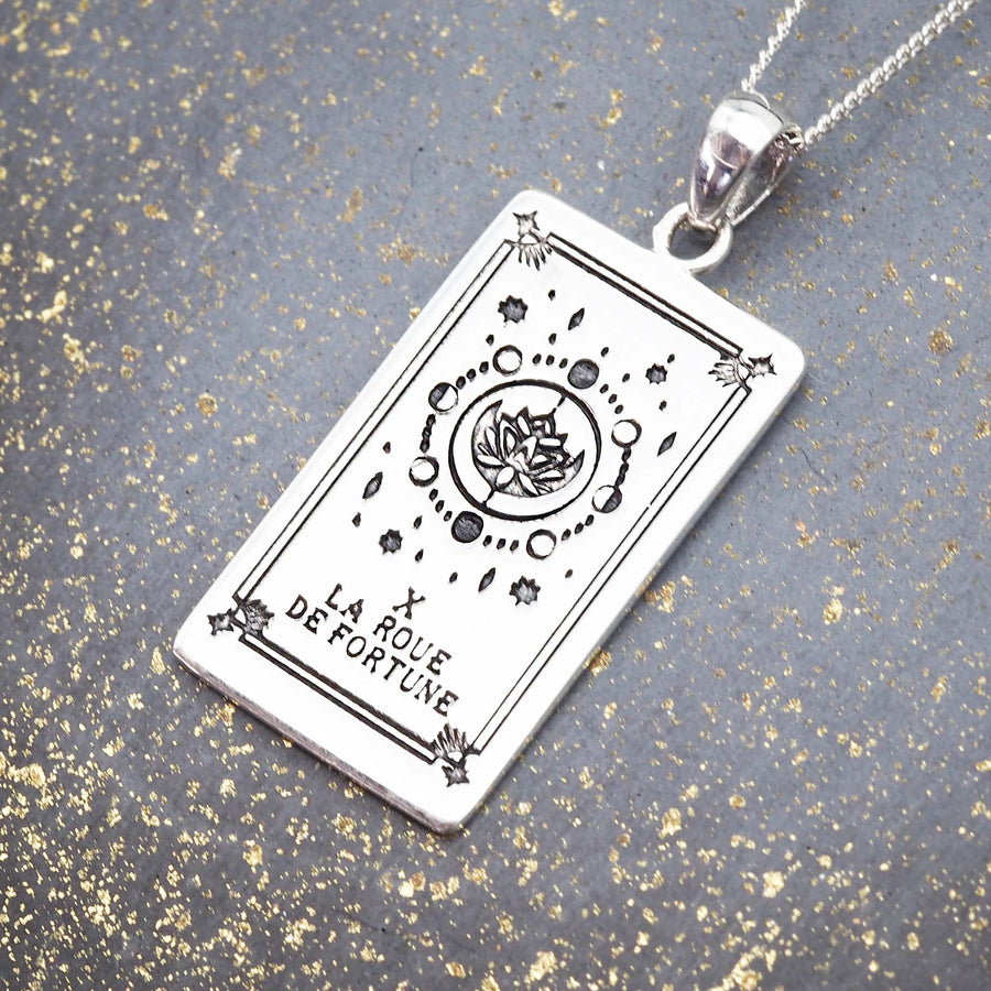 hand drawn tarot card design - sterling silver pendant with the wheel of fortune tarot design made by online jewellery brand indie and harper