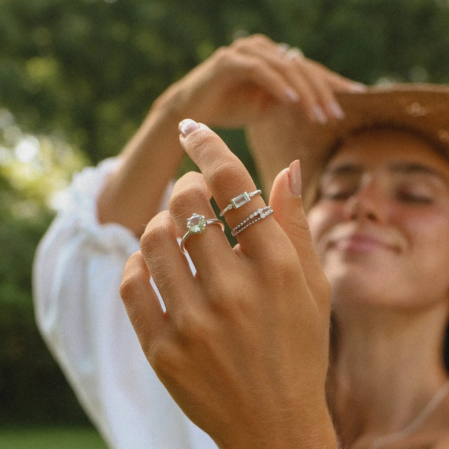 woman wearing three sterling silver rings with topaz, aquamarine and green amethyst stones - womens boho jewellery australia