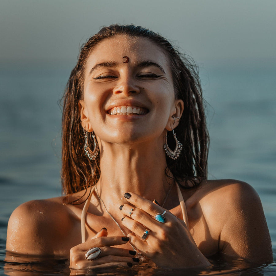 woman in the water wearing boho earrings - boho jewellery by australian jewellery brands indie and Harper 