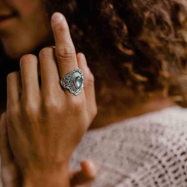 woman wearing a white sweater and a sterling silver labradorite ring - womens boho jewelry by womens jewellery brand indie and Harper 