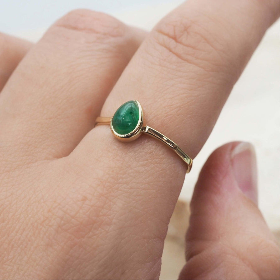 finger wearing gold May Birthstone Ring - Gold Emerald ring - may birthstone jewellery by women’s jewellery brand indie and harper