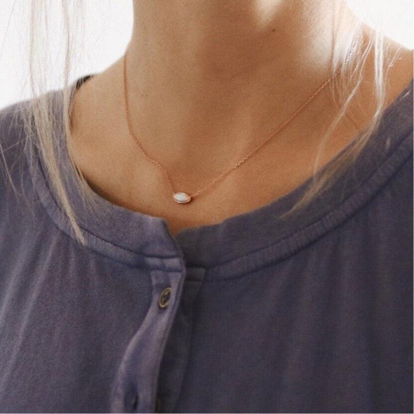 Woman wearing dainty rose gold necklace - opal jewellery by australian jewellery brands indie and harper