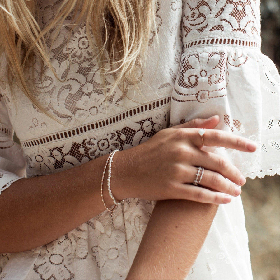 woman in white dress wearing sterling silver Bracelets - sterling silver jewellery by womens jewellery online store indie and harper